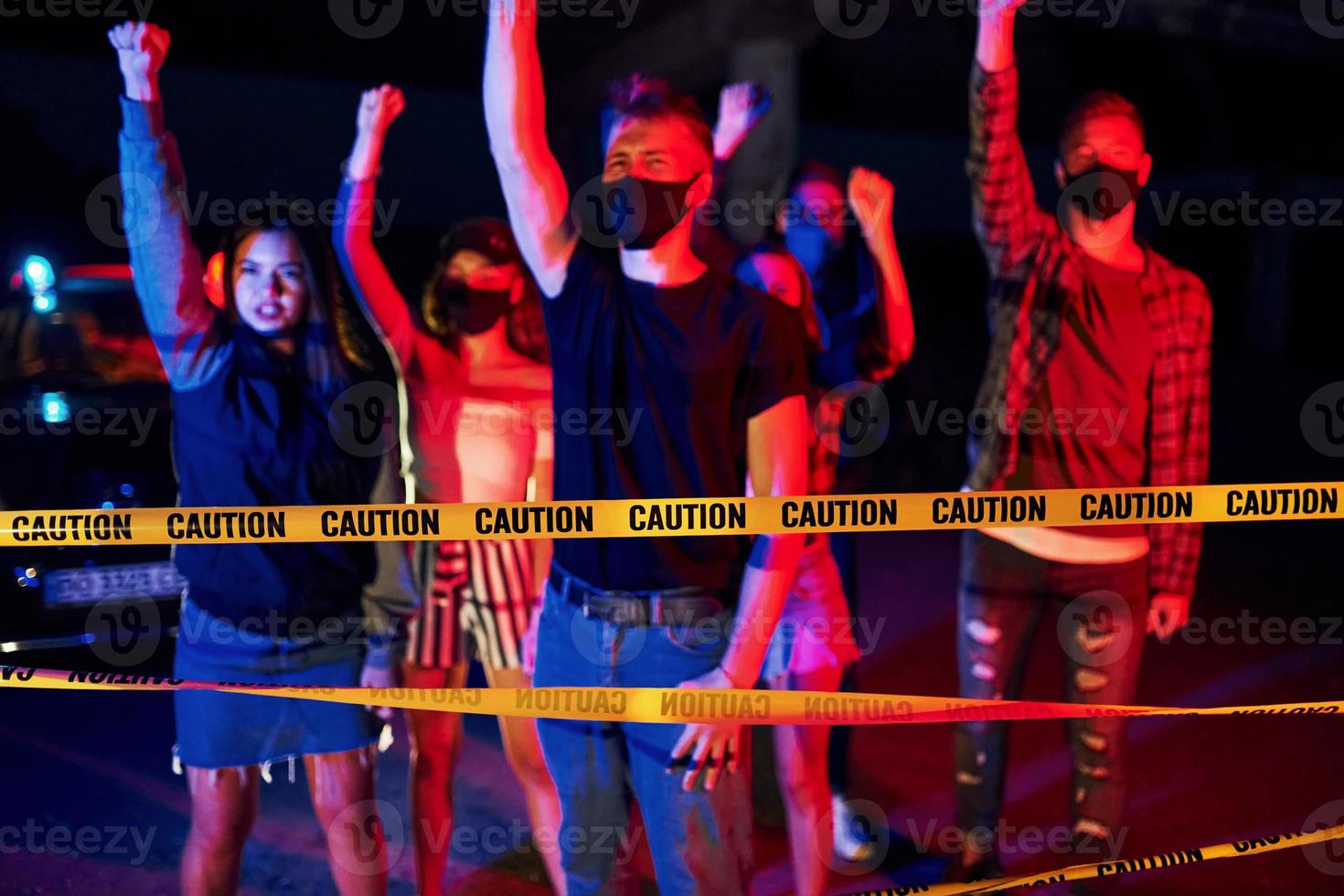 Near police border tape. Group of protesting young people that standing together. Activist for human rights or against government photo