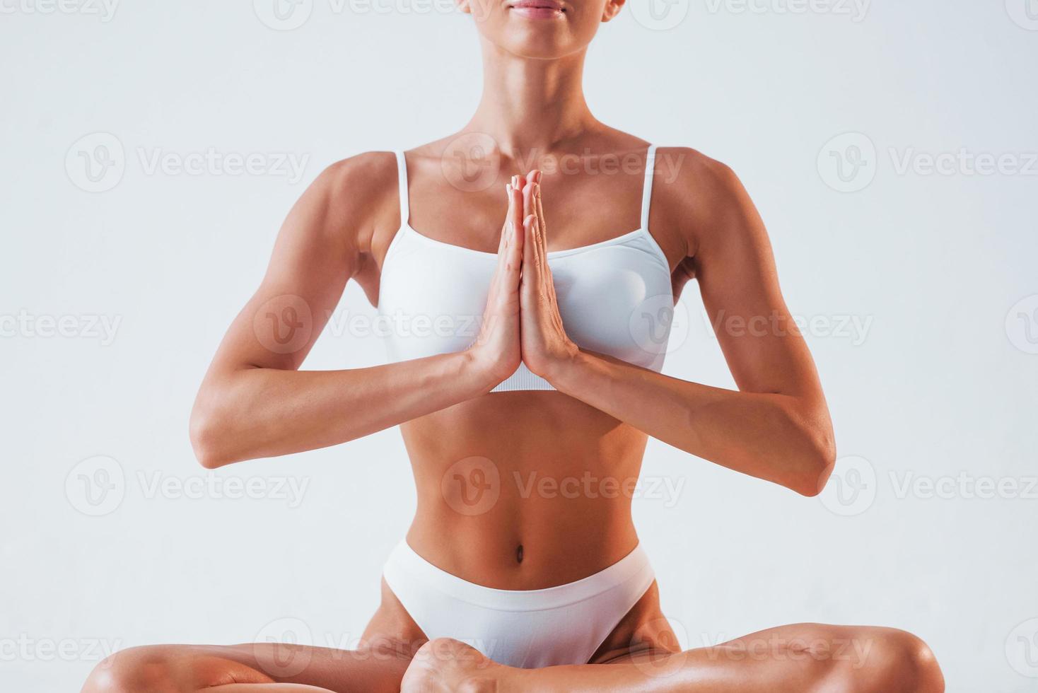 Practicing yoga exercises. Beautiful woman with slim body in