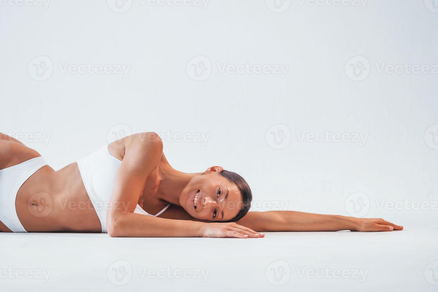 Close up view of stomach. Beautiful woman with slim body in underwear is in  the studio 15301718 Stock Photo at Vecteezy