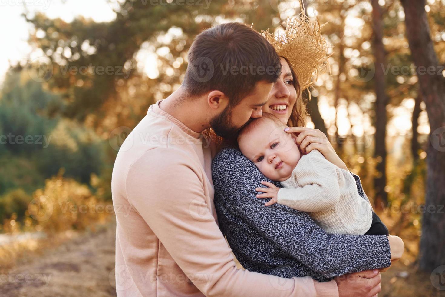 Unity of the people. Happy family of mother, family and little baby rests outdoors. Beautiful sunny autumn nature photo