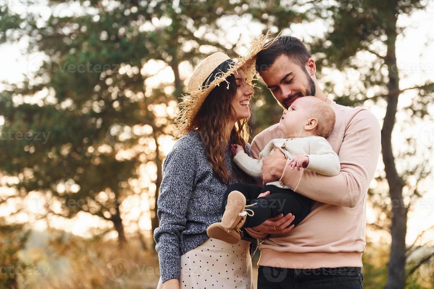 Unity of the people. Happy family of mother, family and little baby rests outdoors. Beautiful sunny autumn nature photo