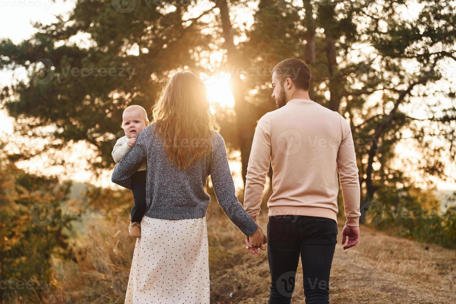 Unity of the people. Happy family of mother, family and little baby rests outdoors. Beautiful sunny autumn nature photo