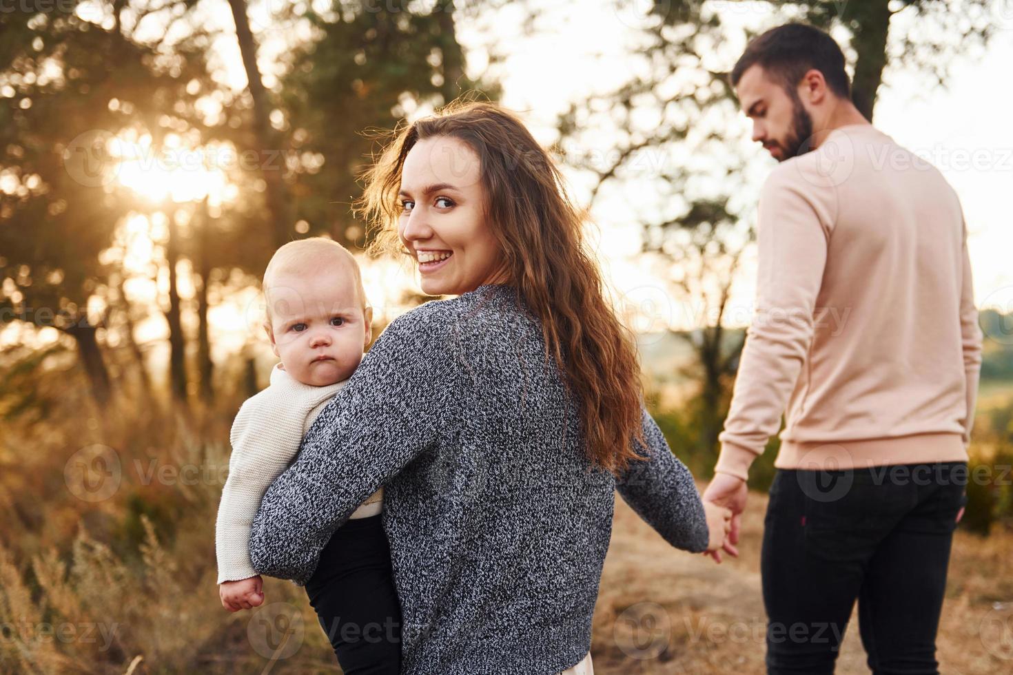 unidad del pueblo. feliz familia de madre, familia y bebé descansa al aire libre. hermosa naturaleza soleada de otoño foto