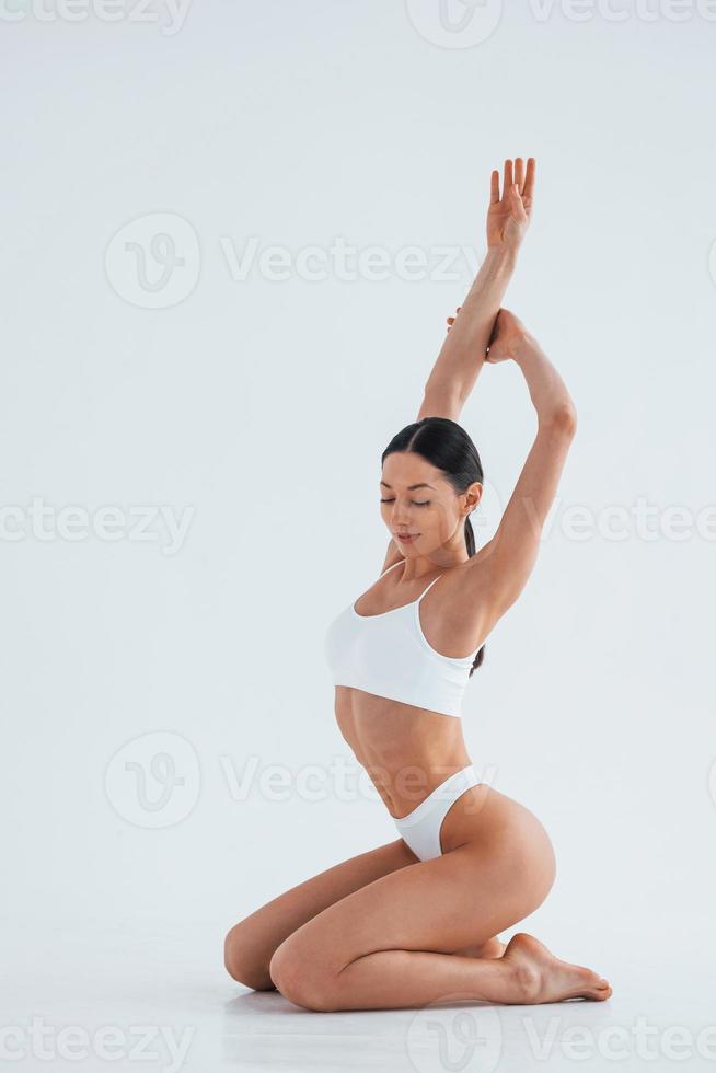 Showing new lingerie. Woman in underwear with slim body type is posing in  the studio 8365741 Stock Photo at Vecteezy