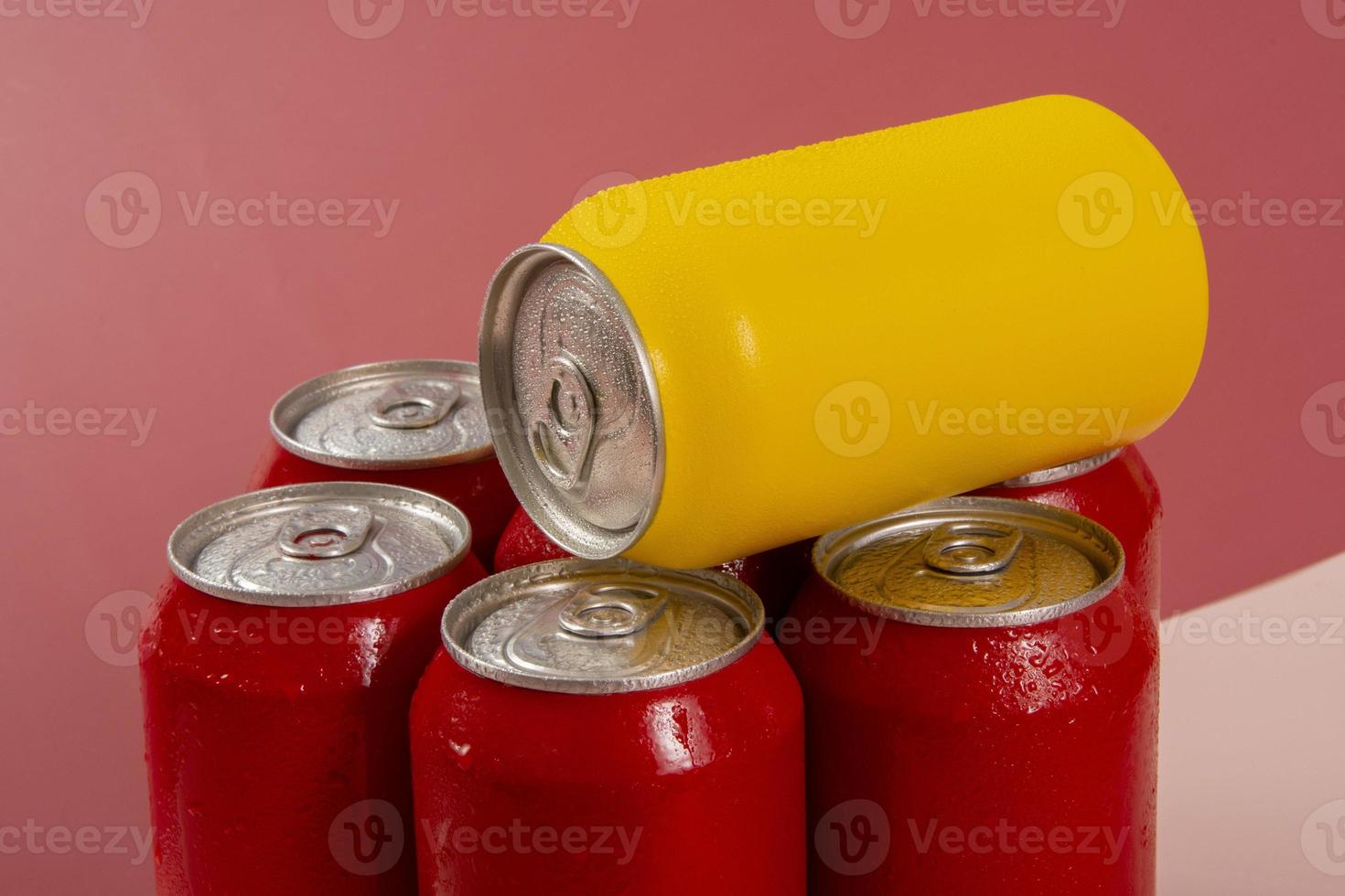 Cold red soda cans with a yellow one for conceptual use photo