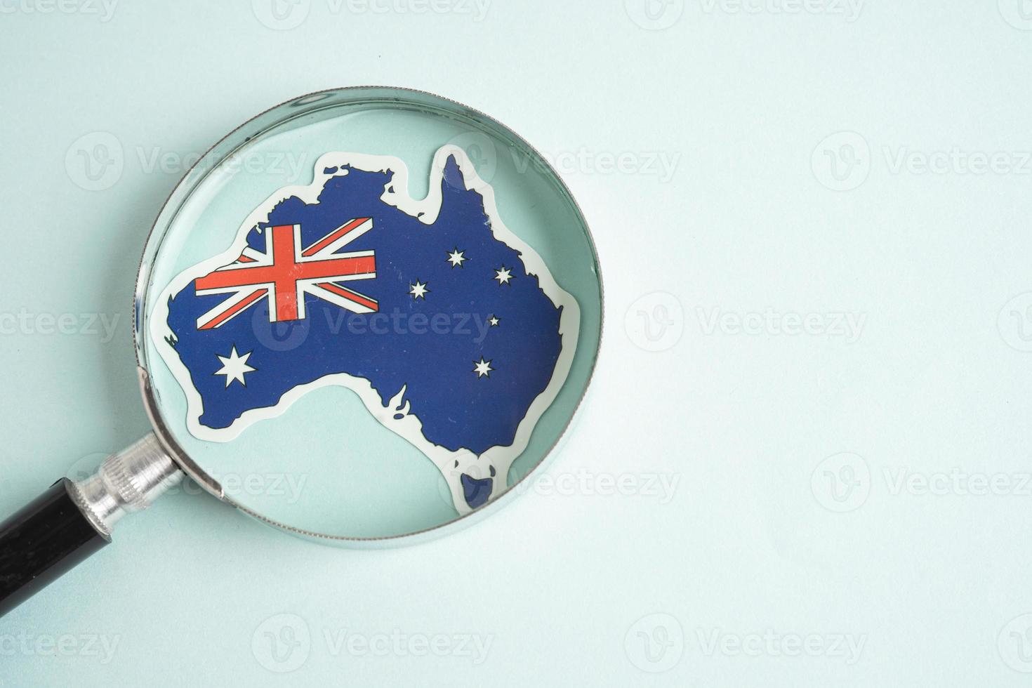 Australia flag and magnifying glass with copy space. photo