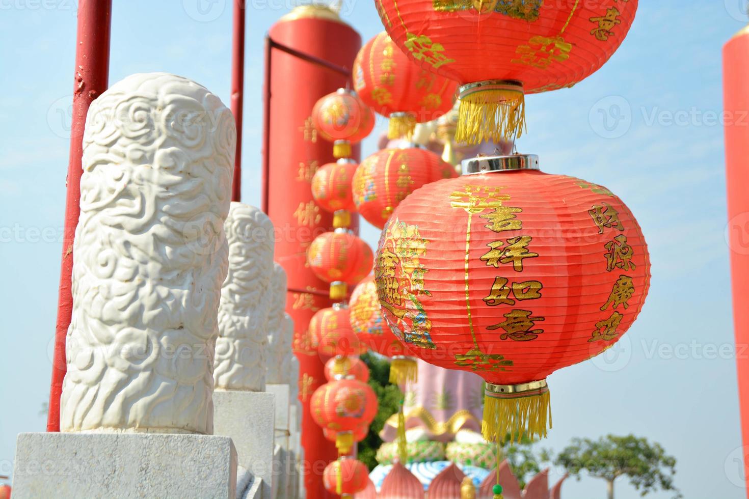 Chinese red lantern has written lucky and chinese pattern decoration hanging the bridge and pillar chinese design at shrine. photo