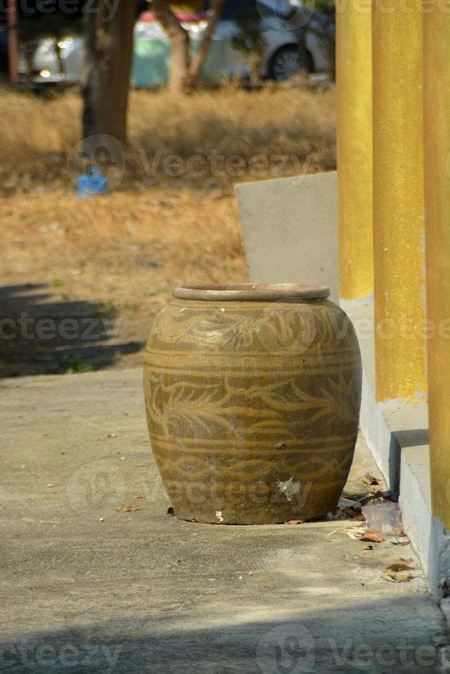 Handicraft, glazed pottery jar with ancient dragon pattern for general storage jar. photo