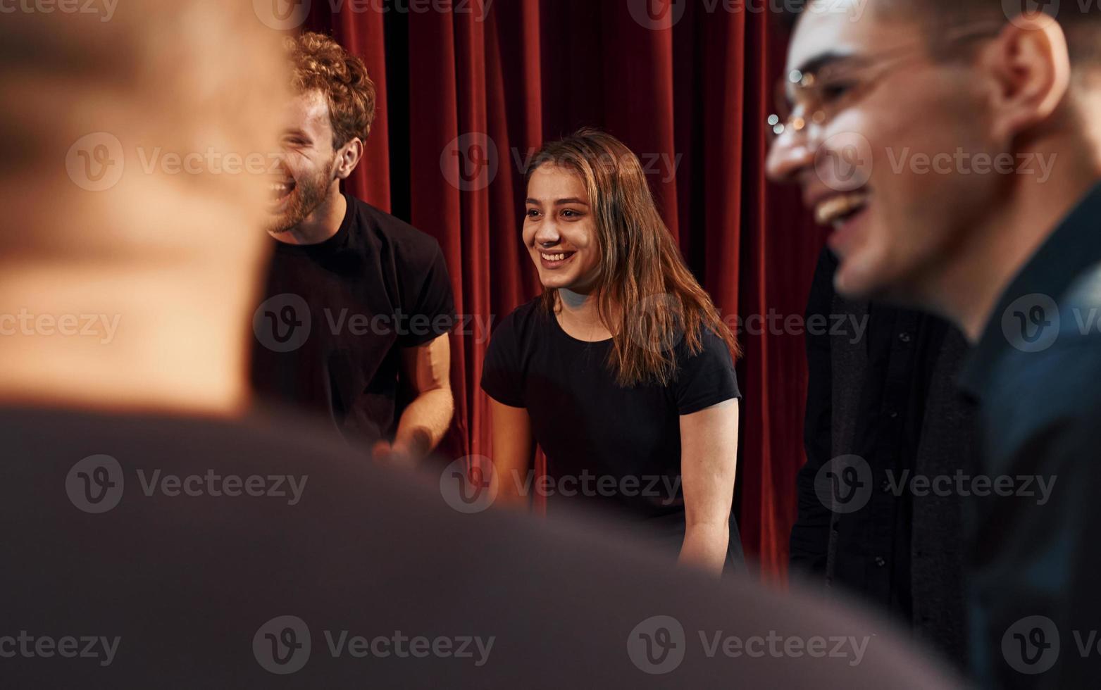 Group of actors in dark colored clothes on rehearsal in the theater