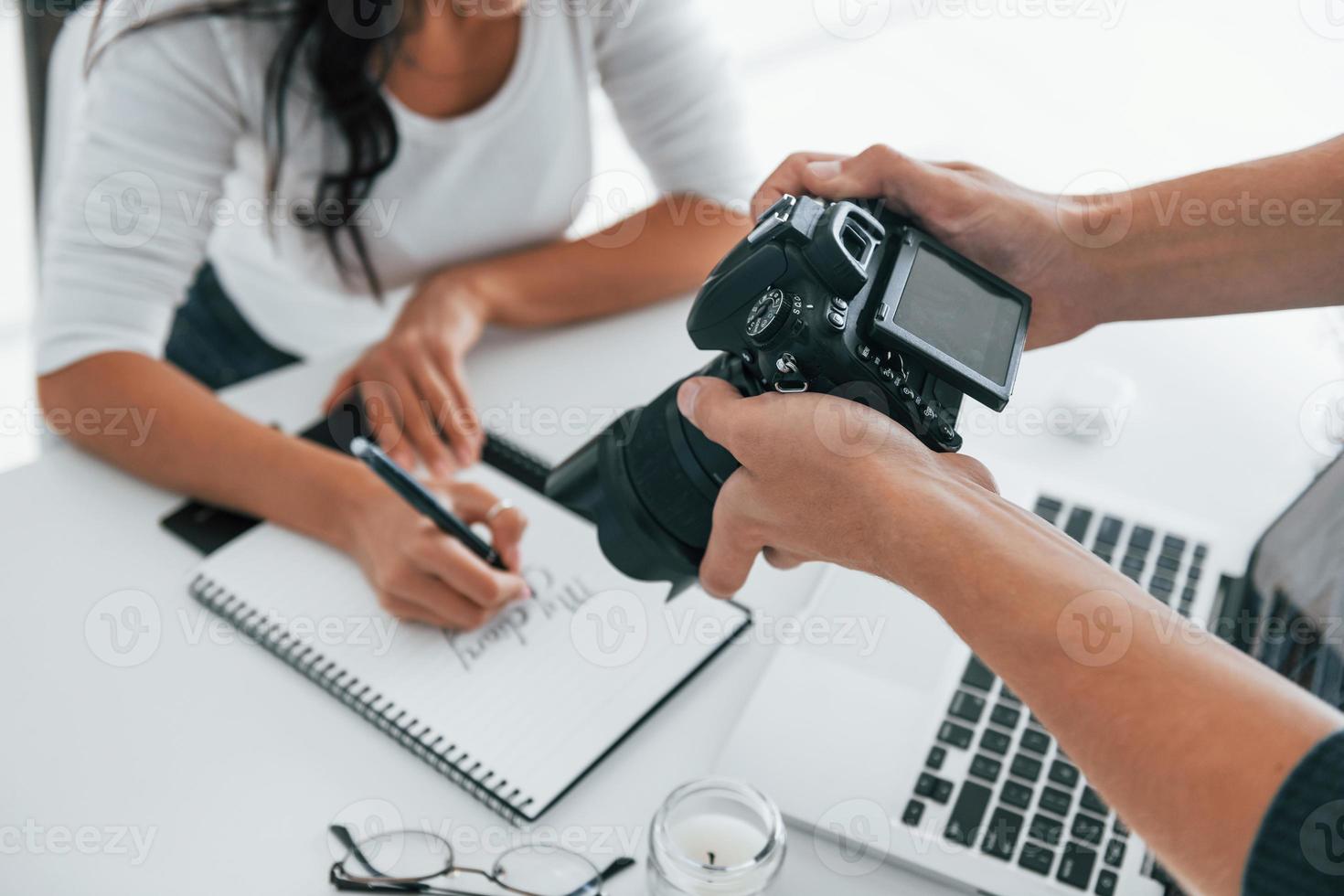 Photographer at work. Two young female freelancers indoors in the office at daytime photo