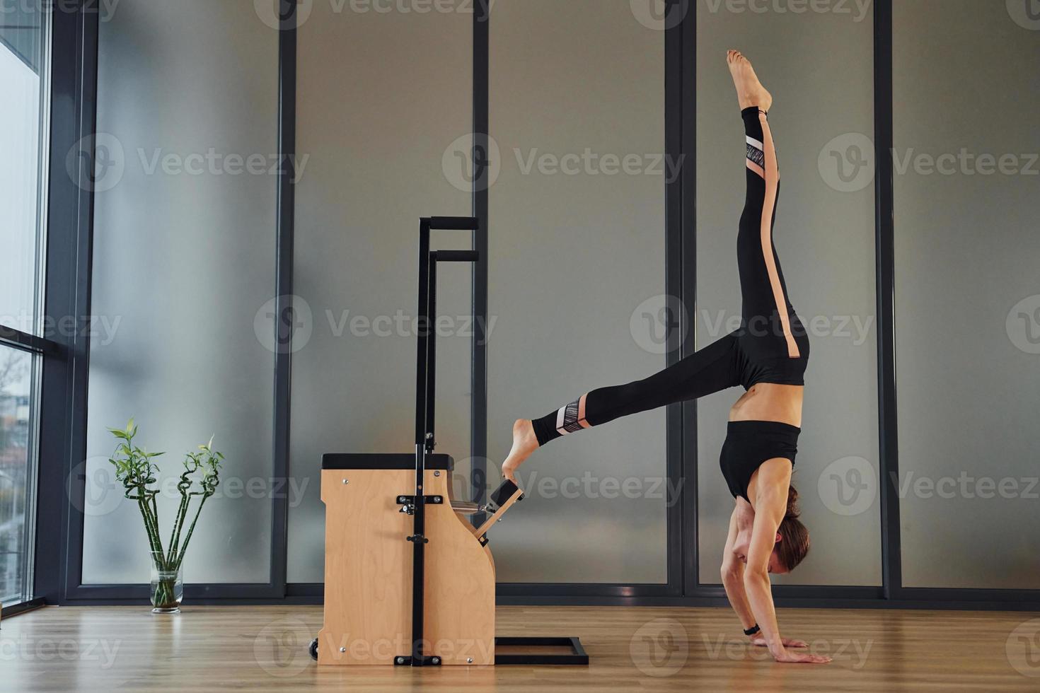 Young woman in sportive wear and with slim body have fitness yoga day indoors photo