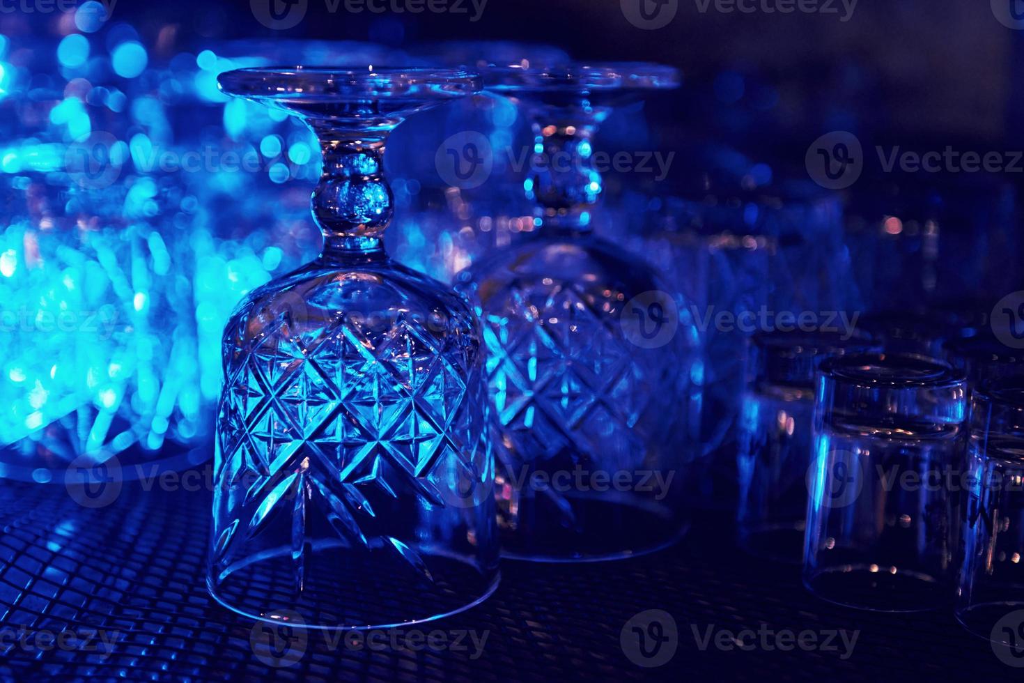 Close up view of row of empty glasses on table in the pub indoors photo