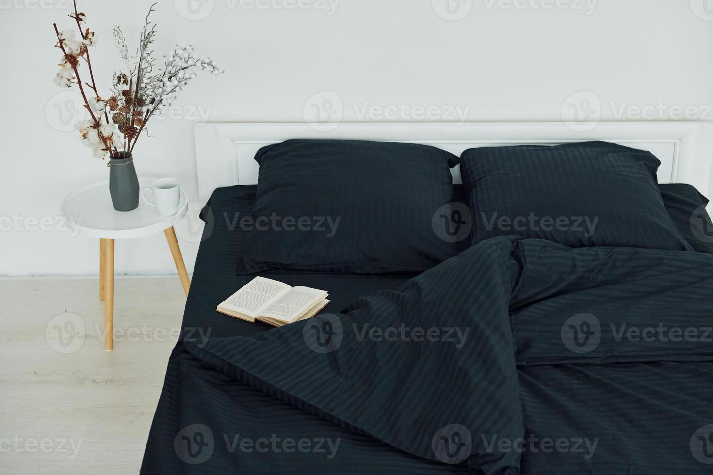 Book on the bed. Interior and design of beautiful modern bedroom at daytime photo