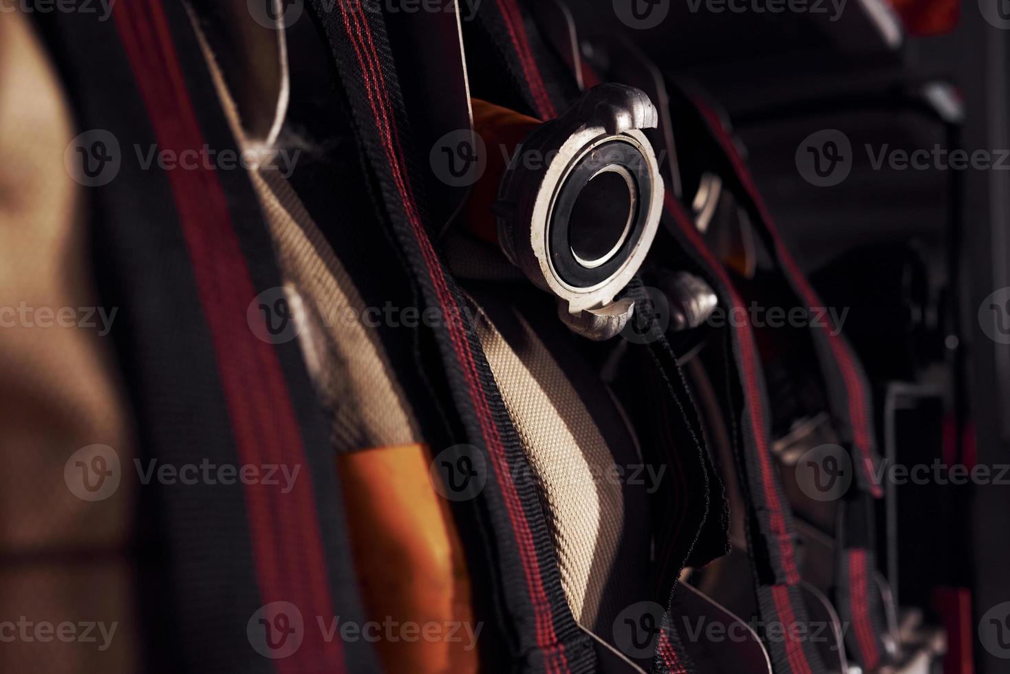 Firefighter's equipment in the car. Hoses hanging inside of vehicle photo