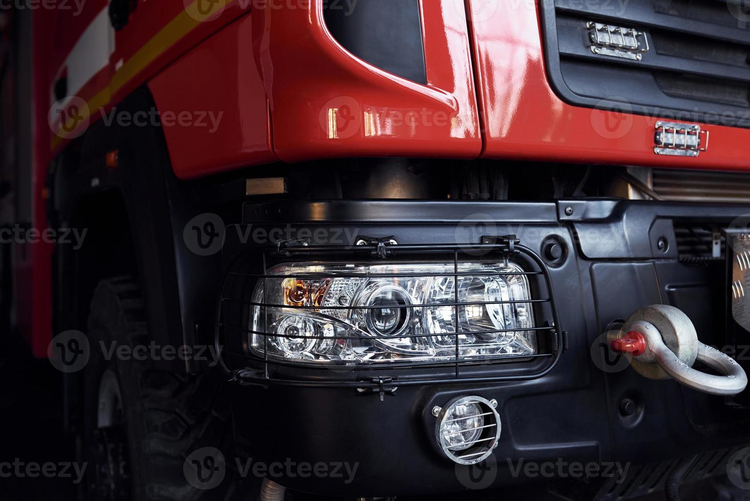 Close up view of red modern fire truck. Front part of vehicle photo