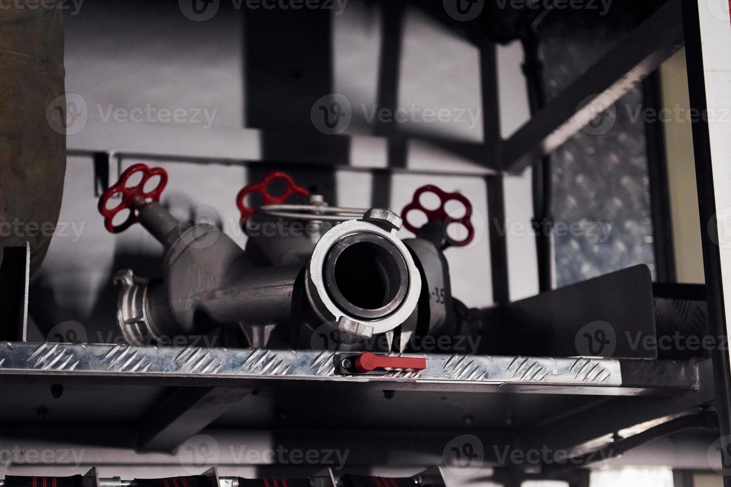 Inside of fire truck. Close up view of equipment and hoses photo