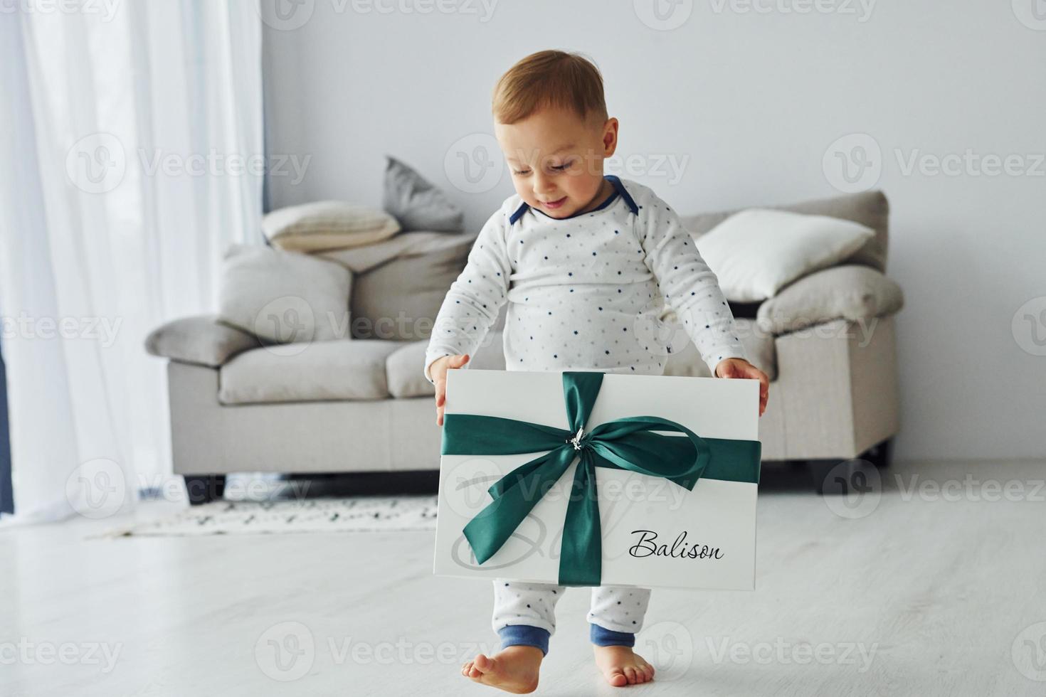 Cheerful little boy have fun. Interior and design of beautiful modern bedroom at daytime photo