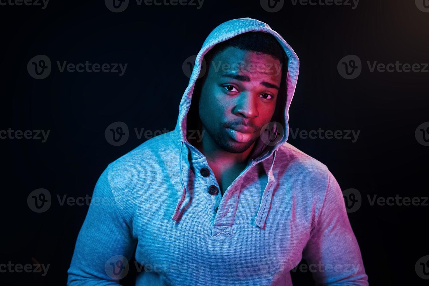 Futuristic neon lighting. Young african american man in the studio photo