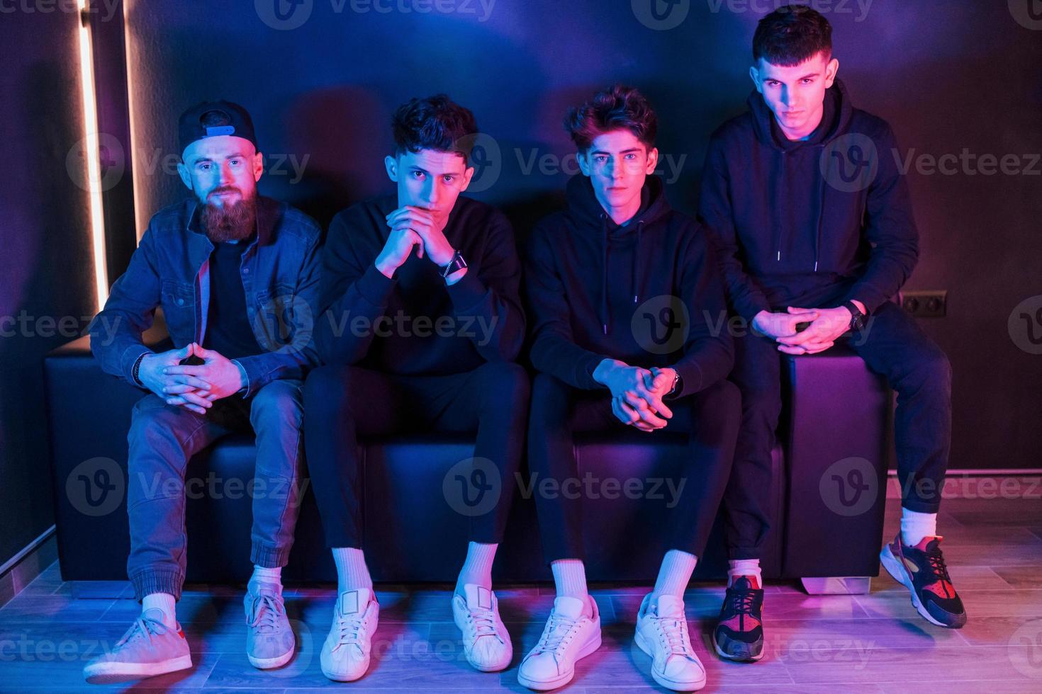 Group of people is together in the studio with futuristic neon lighting photo