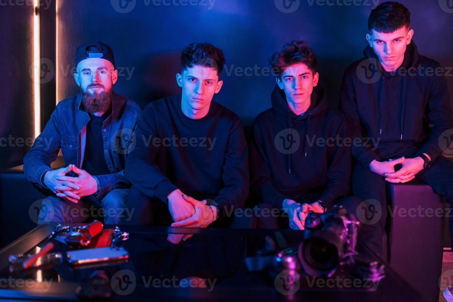 Group of people is together in the studio with futuristic neon lighting photo