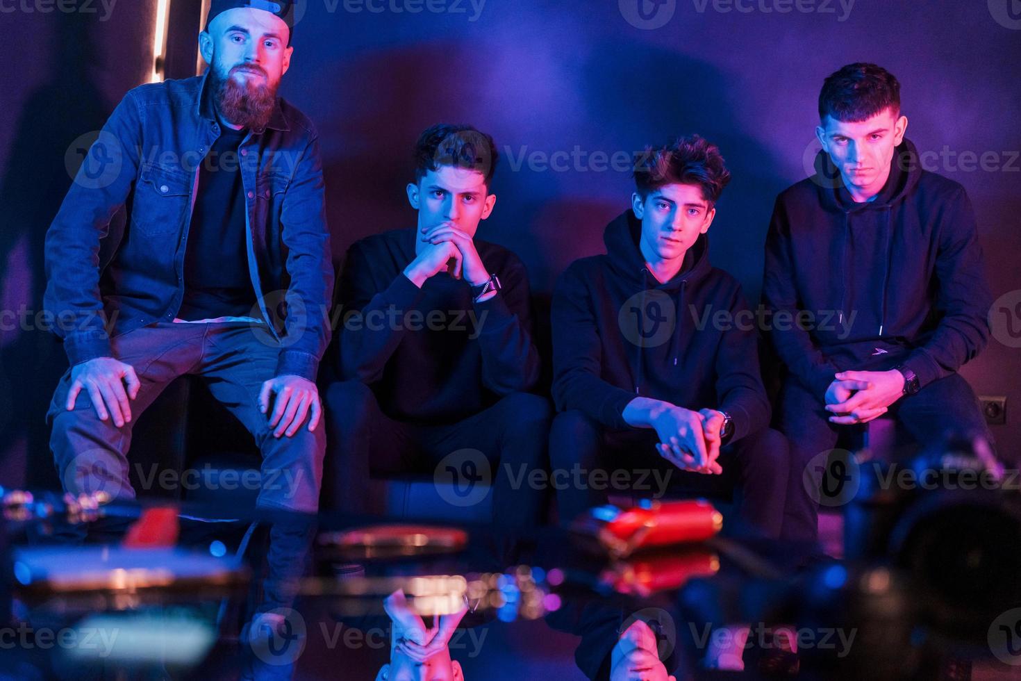 grupo de personas está junta en el estudio con iluminación de neón futurista foto