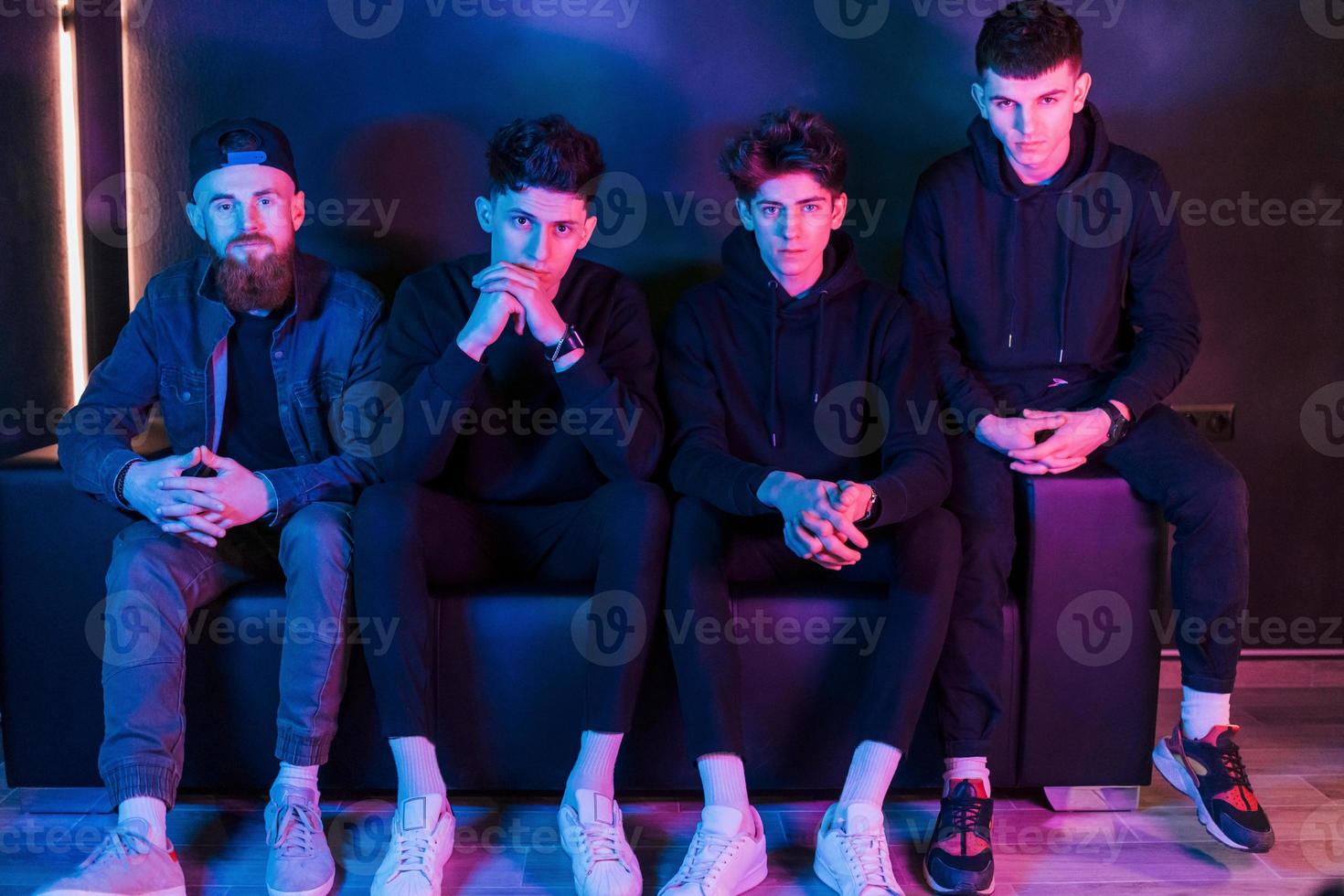 Group of people is together in the studio with futuristic neon lighting photo