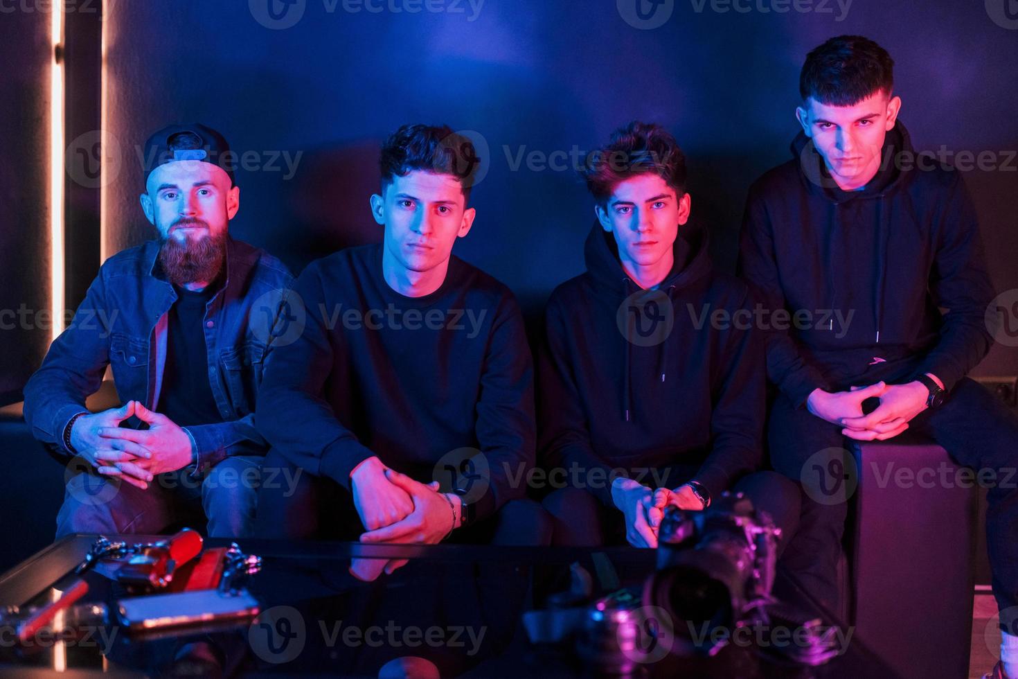 Group of people is together in the studio with futuristic neon lighting photo