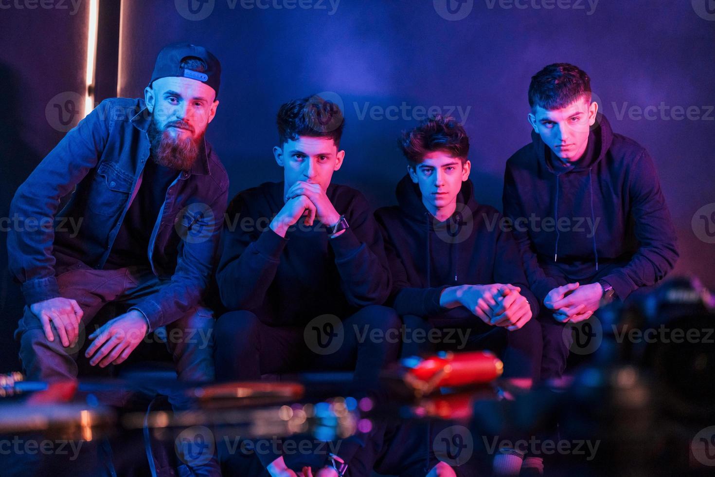 Group of people is together in the studio with futuristic neon lighting photo