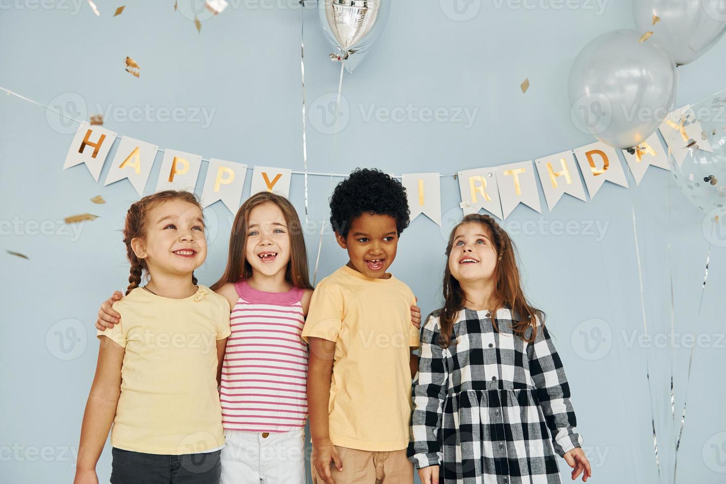 Posing for the camera. Children on celebrating birthday party indoors have fun together photo