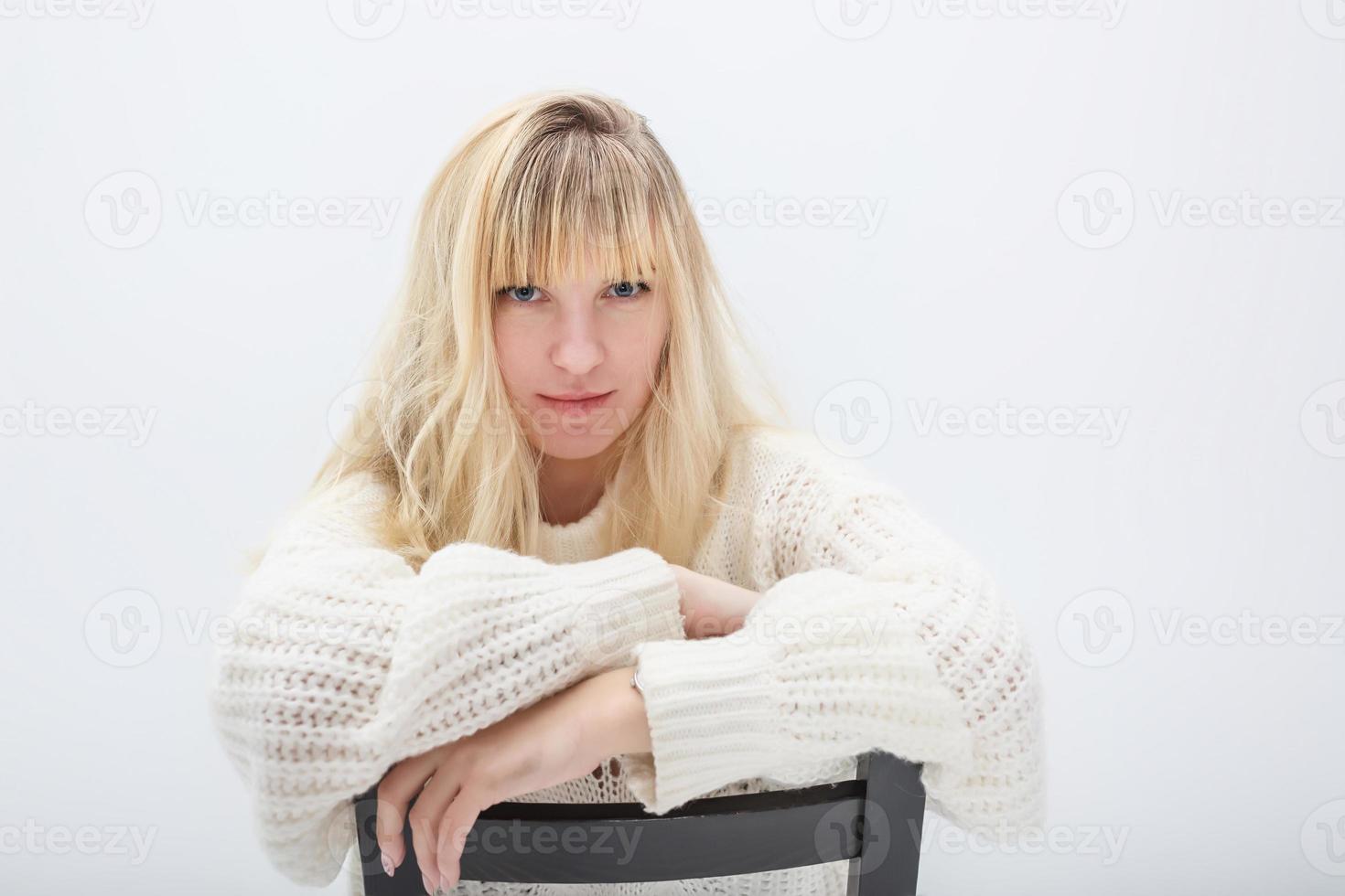 close up portrait of blonde girl model in white wool sweater on white background in studio photo