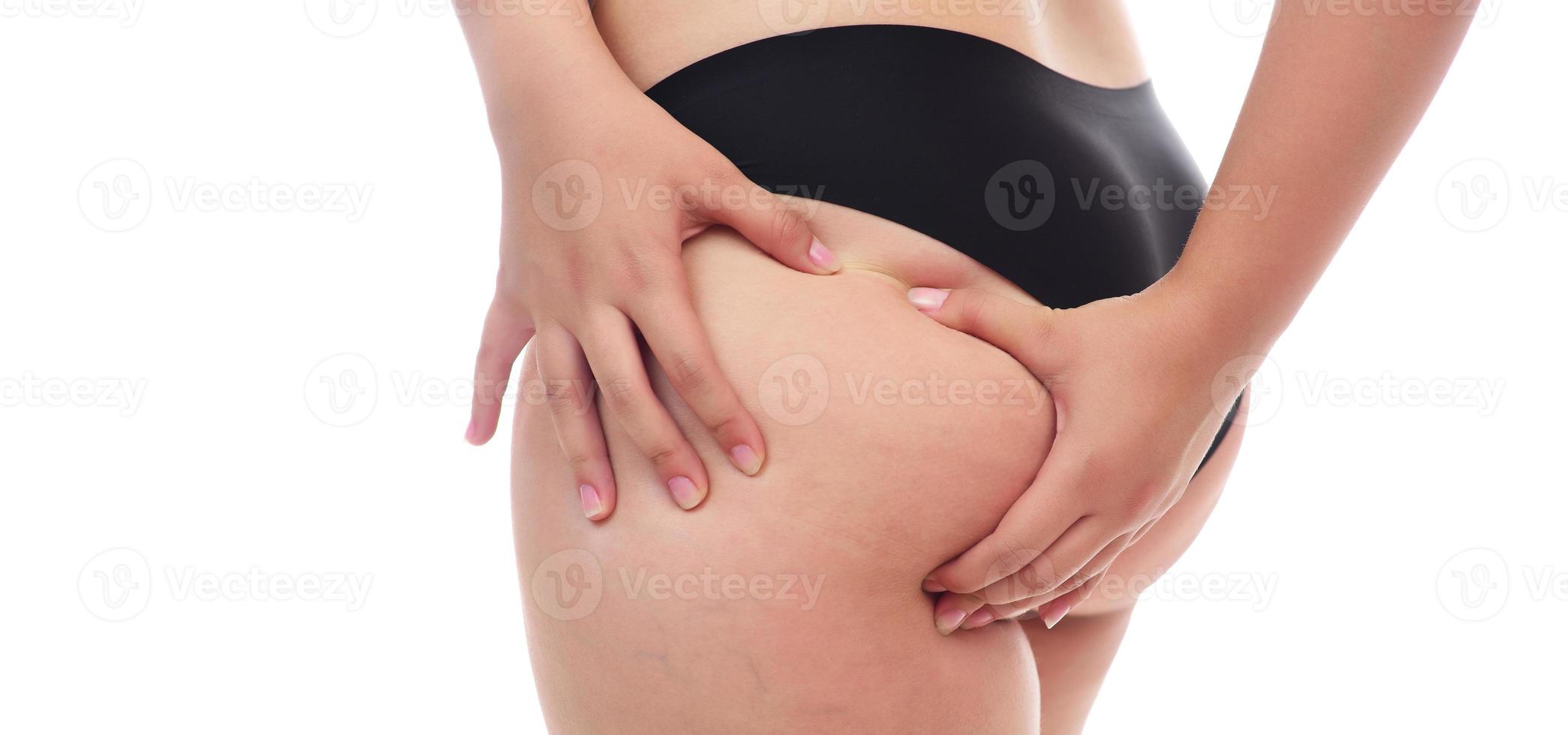 fat female pinching her fat on her ass, isolated on white background. photo