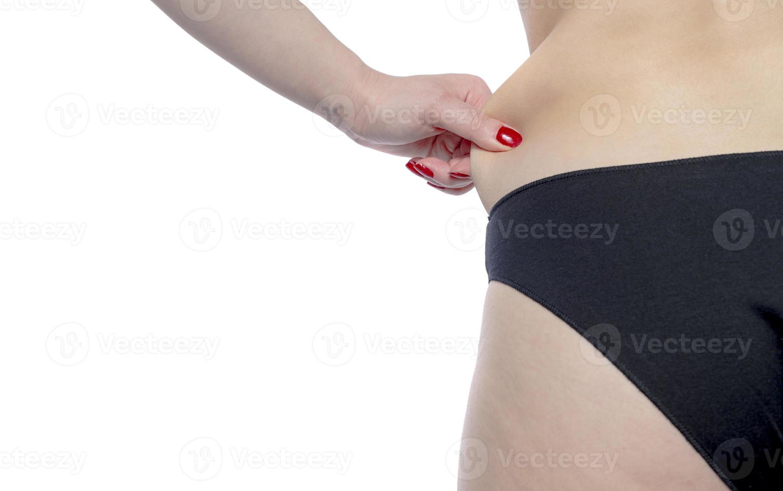 mujer pellizcando su cintura grasa foto