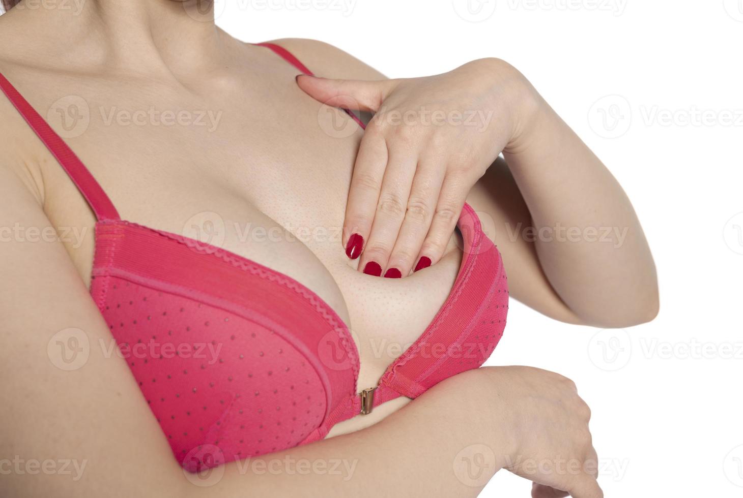 photo of a female checking her breast for cancer. Breast test, woman examining her breasts for cancer, heart attack, pain in human body,