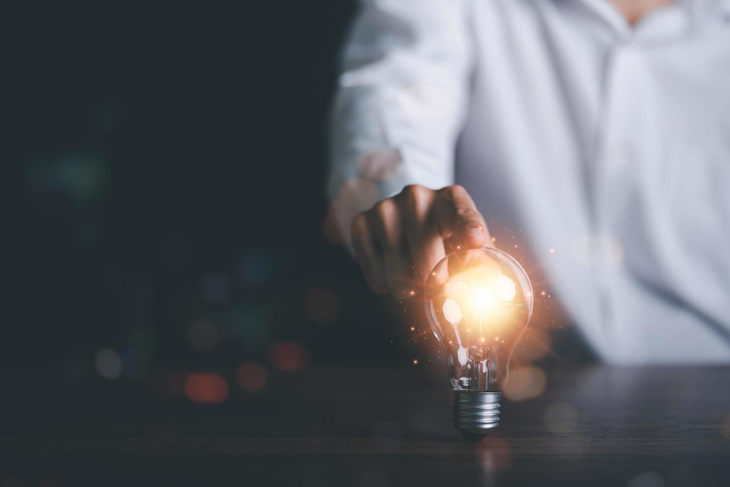 for Concept new idea, concept with innovation and inspiration, innovative technology in science concept and modern business development,creative idea,man pointing light bulb on table photo