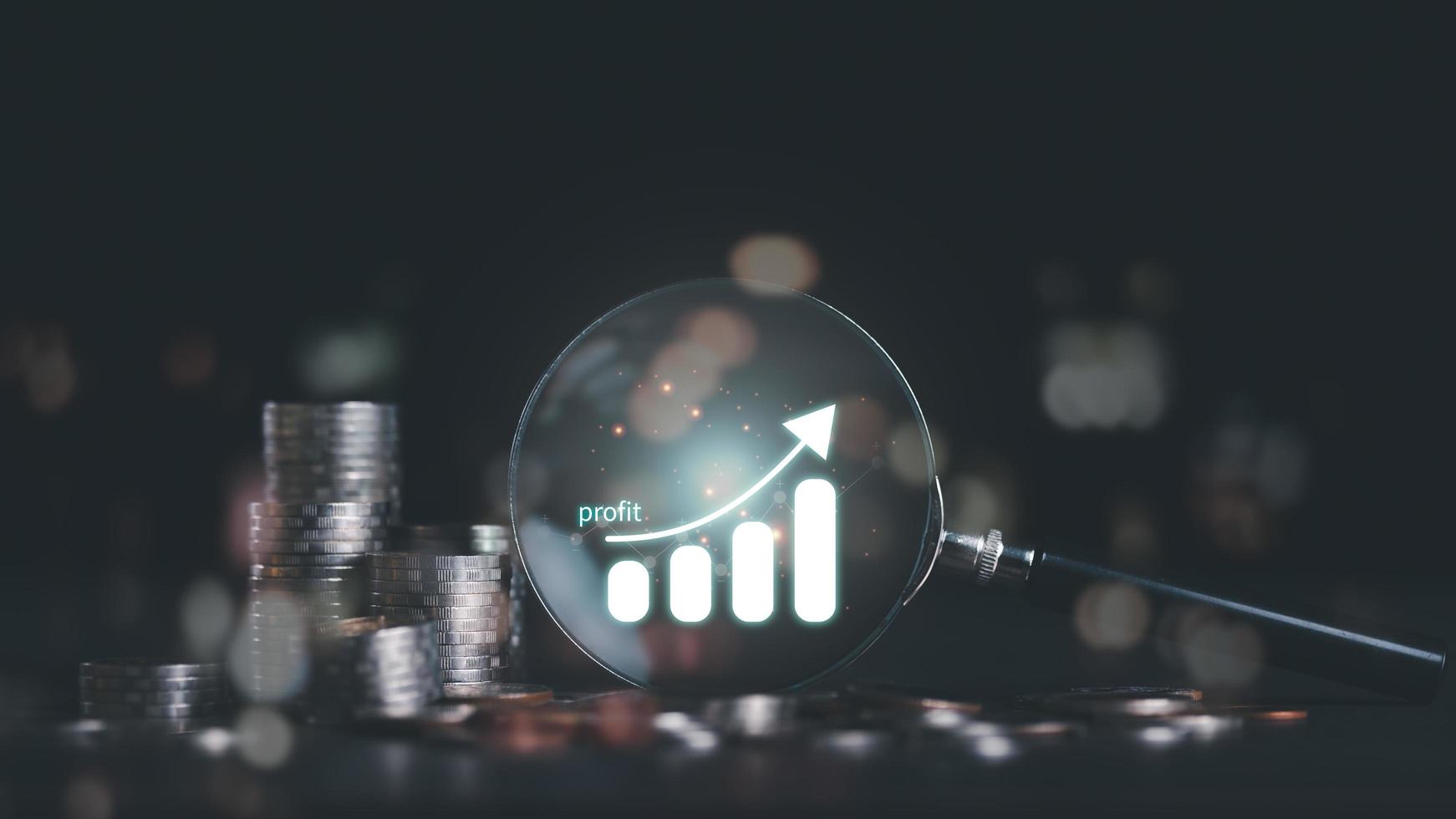 Stack of coins and a magnifying glass on the table,icon representation of success and profit,concept of progress in development financial performance and investment,Fund growth and savings photo