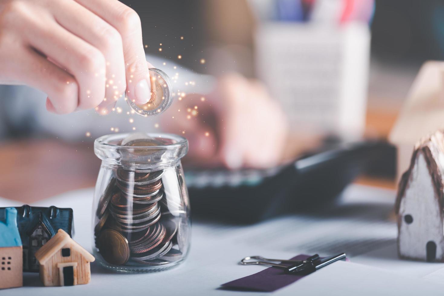 Businessman putting coins into glass jar ,and calculate the profit growth of savings,progressive concepts for the development of financial results and investments,Business strategy for future goals photo