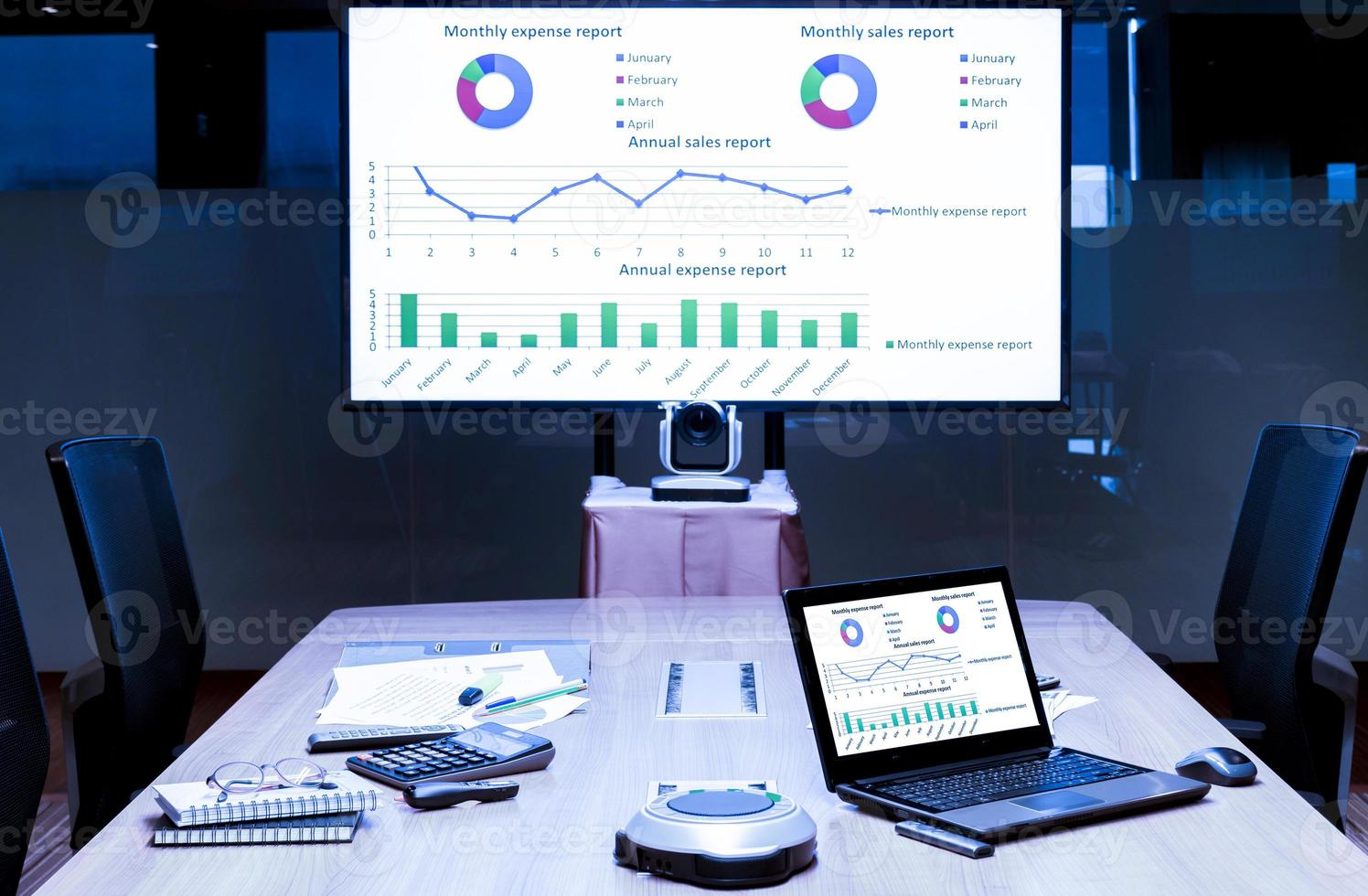 Mock up presentation on display television and laptop on table in meeting room photo