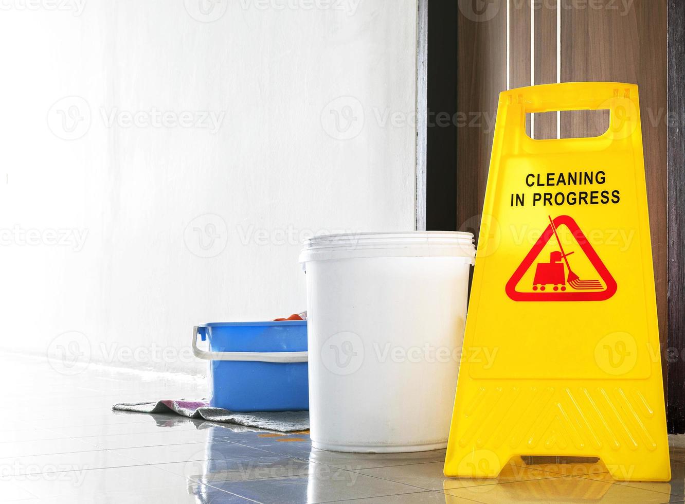 Close up yellow warning sign with message Cleaning in progress photo