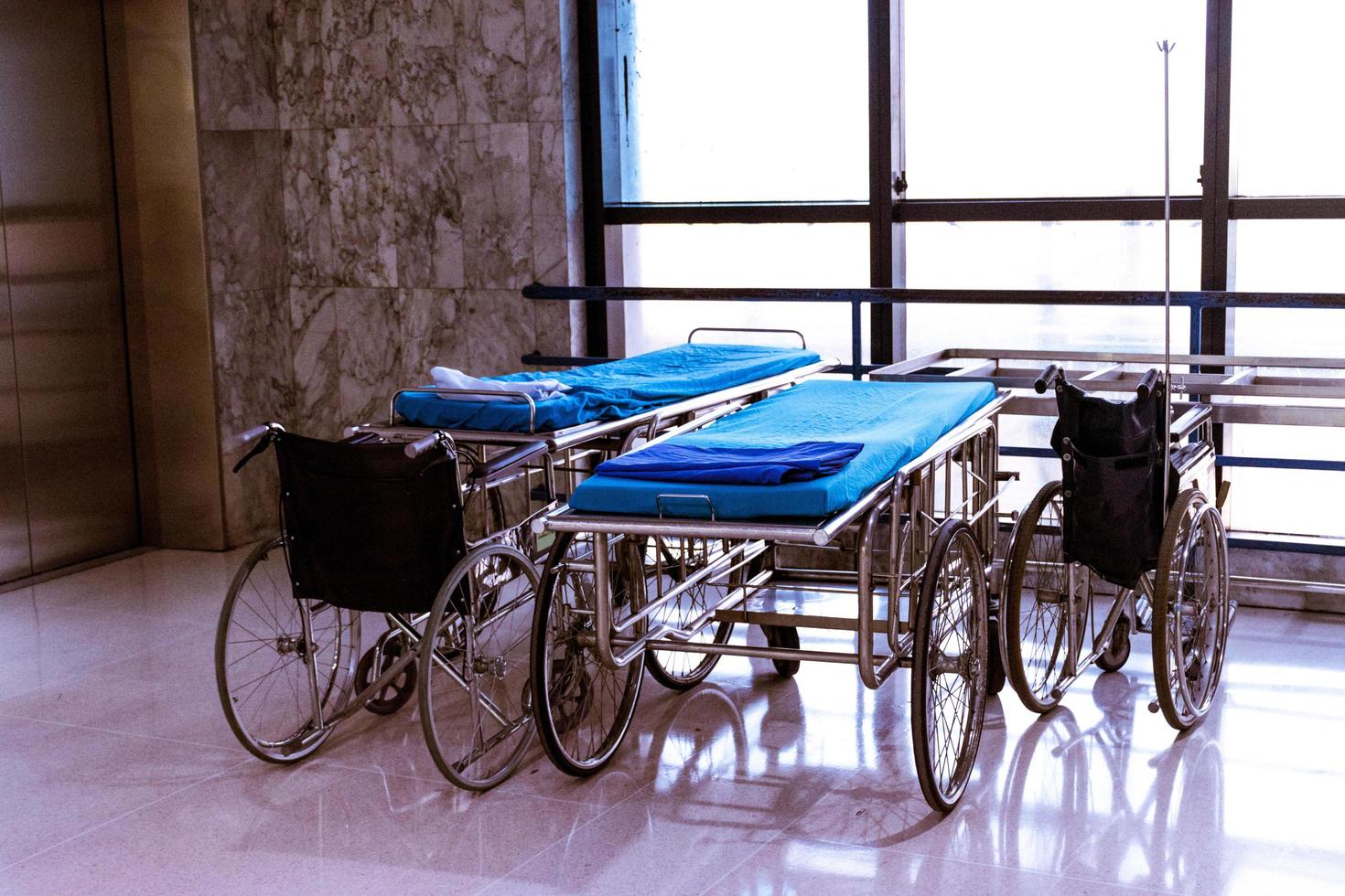 wheelchair and bed at hospital area photo