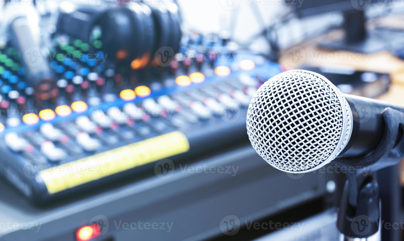 The microphone on tripod with mixer background in sound control room. photo