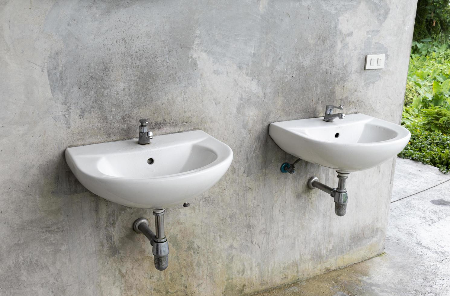 Two wash basin with gray loft wall photo