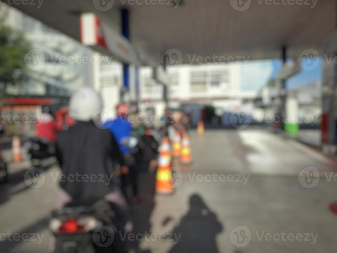 defocused abstract blurred of queue for refueling at a gas station photo