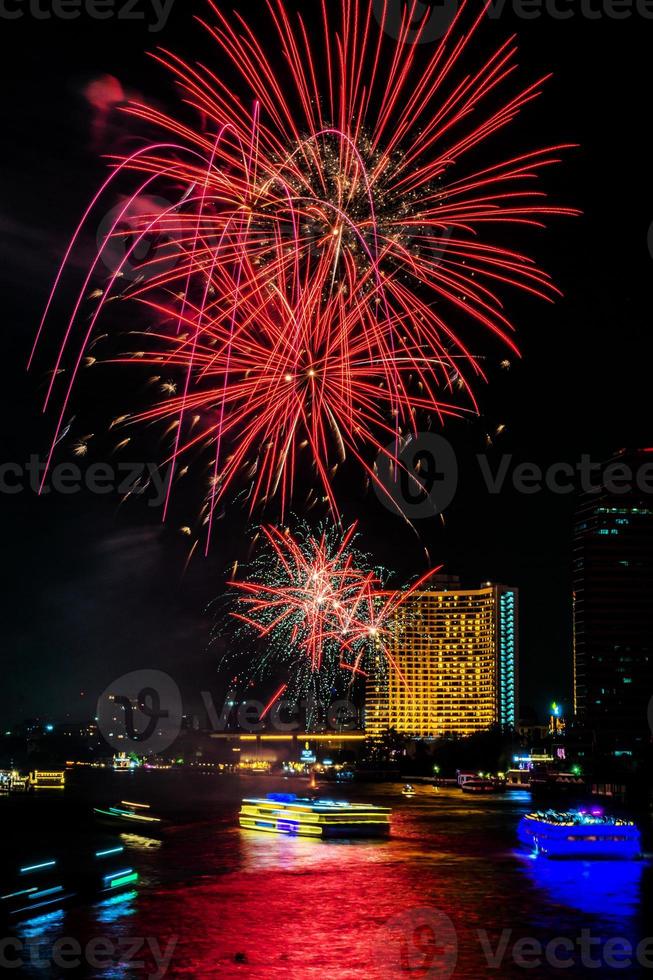 fireworks on the river in the dark sky photo