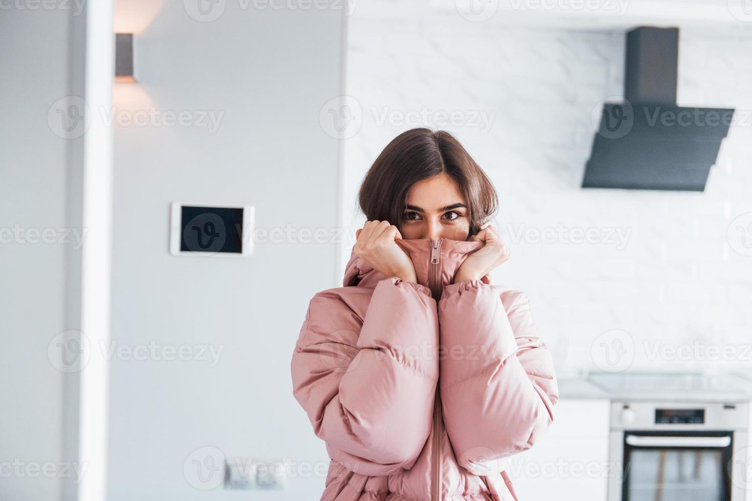 Climate control. Young woman is indoors in smart house room at daytime photo