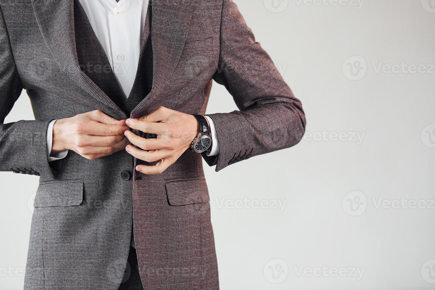 Close up view. Young stylish businessman in suit indoors. Conception of success photo