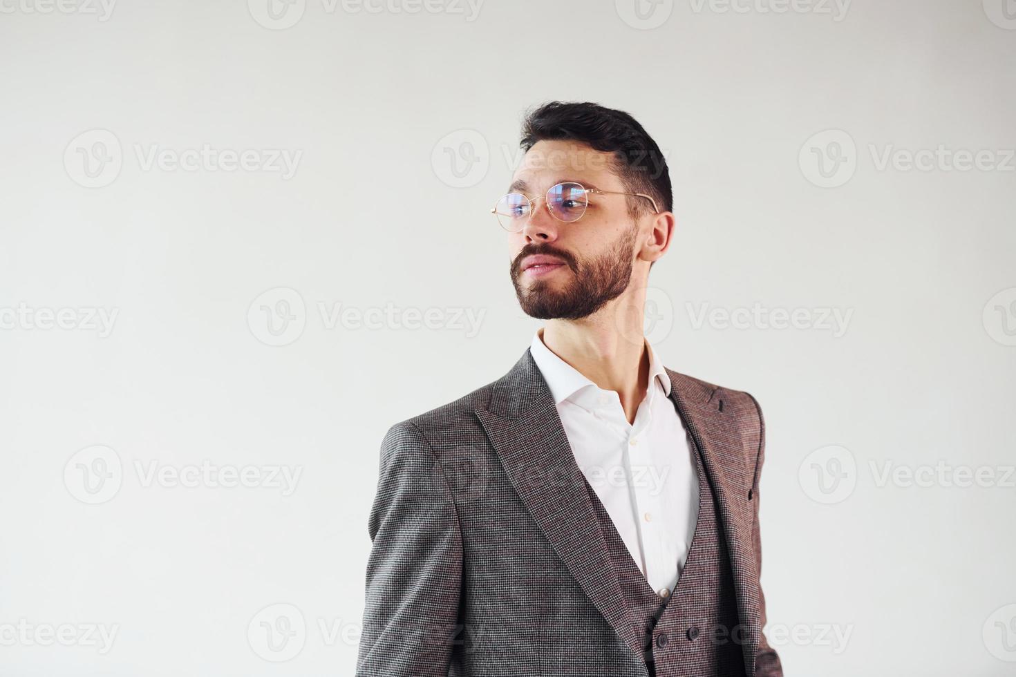 Young stylish businessman in suit indoors. Conception of success photo