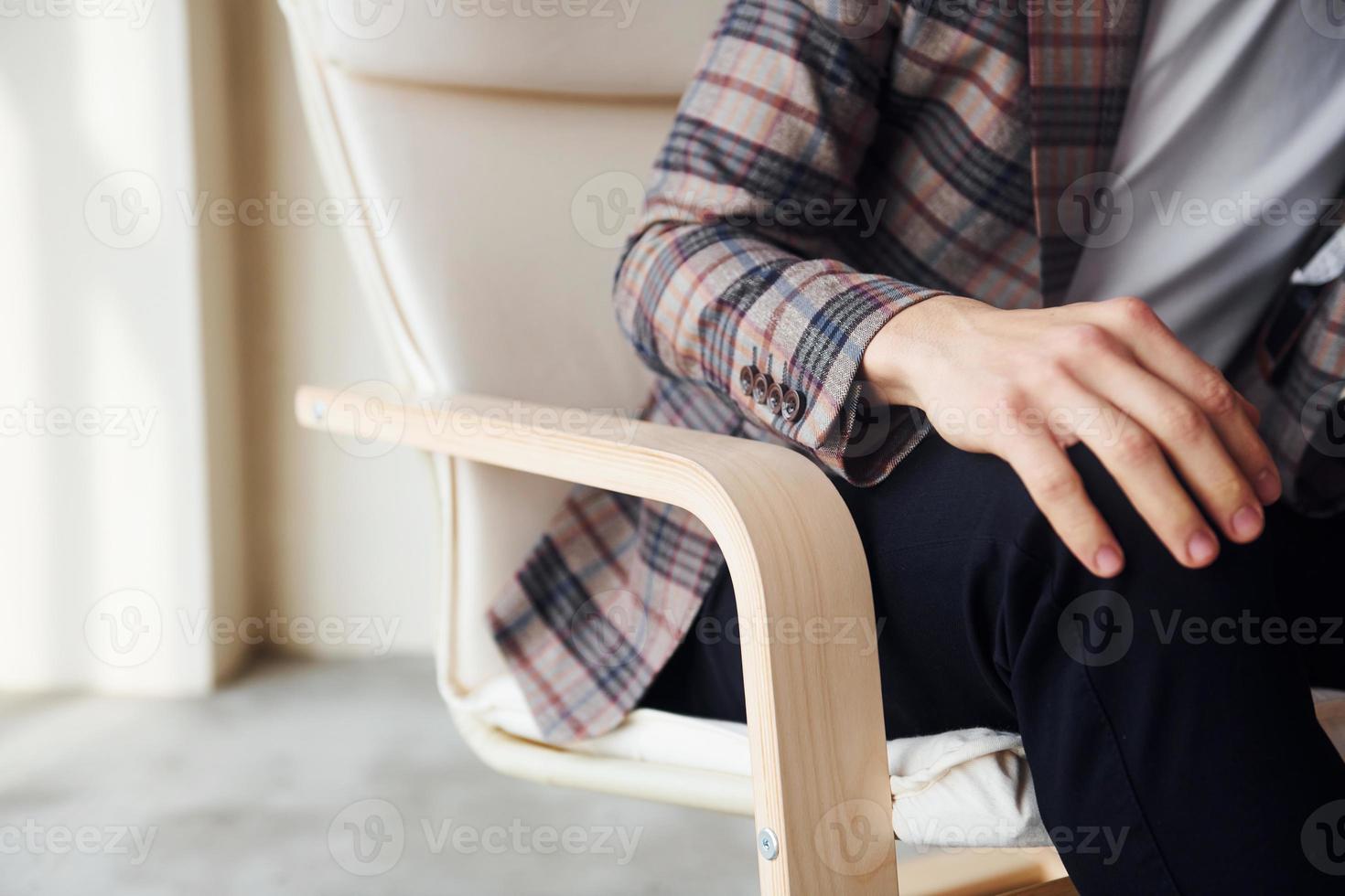 Close up view. Young stylish businessman in suit indoors. Conception of success photo