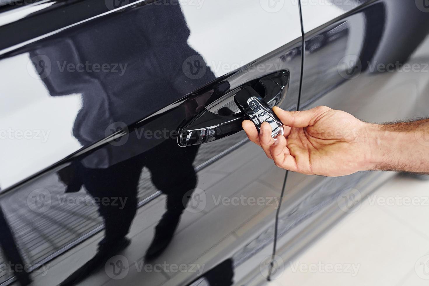 Close up view of man's hand that holds automobile keys photo