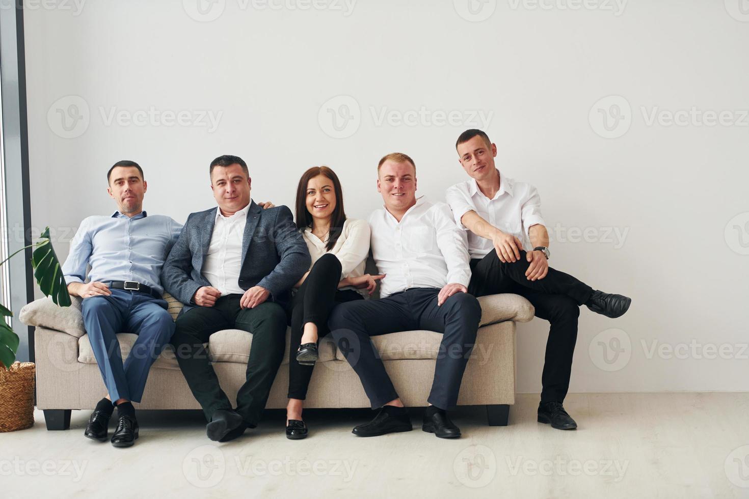 Group of office workers in formal official clothes is together indoors photo