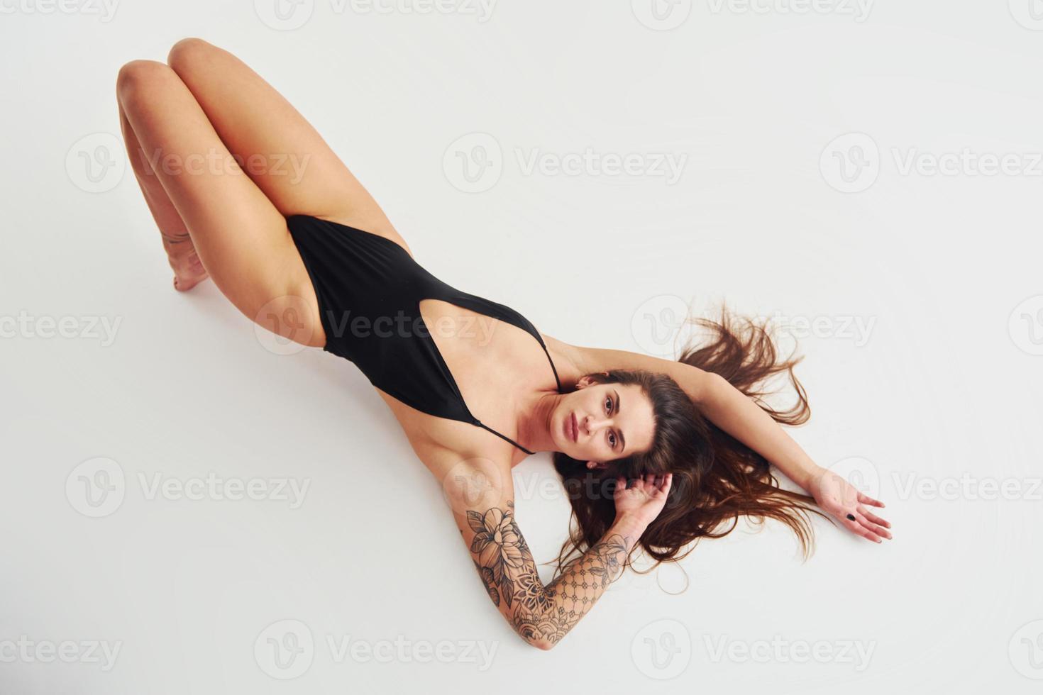 Beautiful seductive sporty woman with sexy body is posing in the studio photo